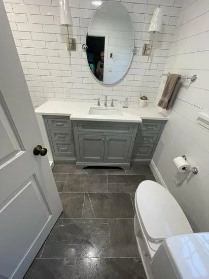 finished bathroom with hexagon shower floor tile and 12x24 porcelain flooring